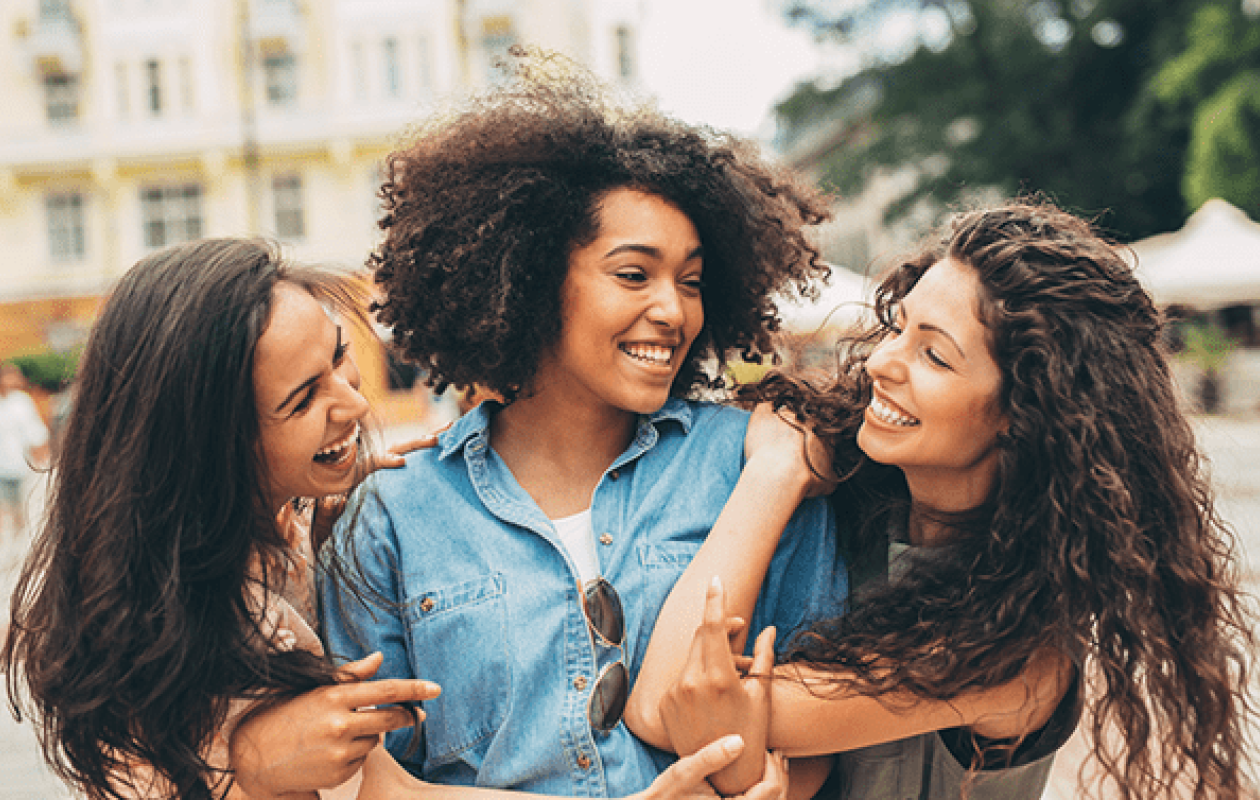 Three women smiling together