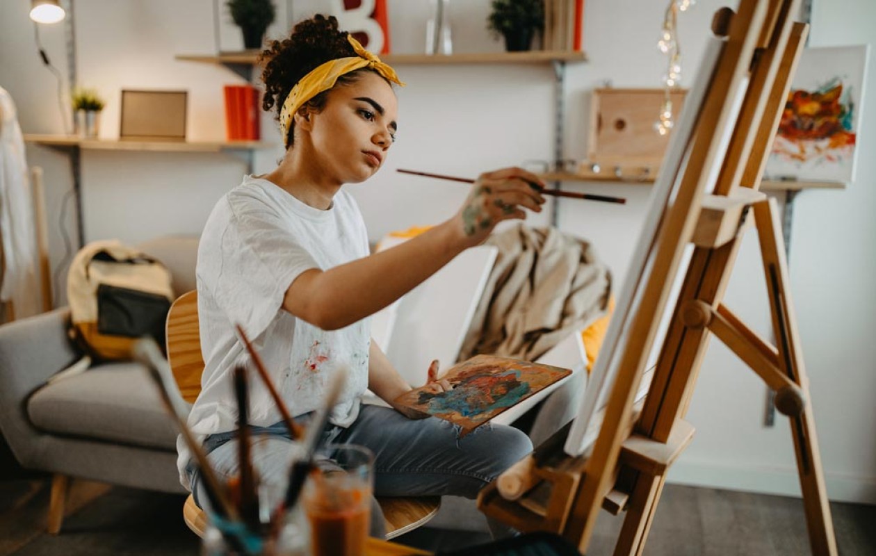 Young lady painting in her living room